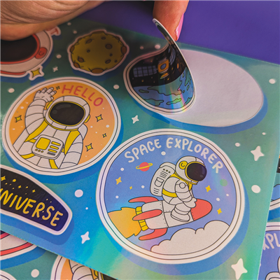 Colorful space-themed stickers with astronauts and celestial designs on a blue background.